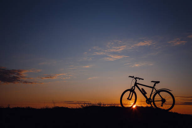 istock silhouette of a bicycle on the sunset sky 1253265520