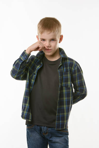 istock A ten year old boy wipes his nose with his finger 1253265633
