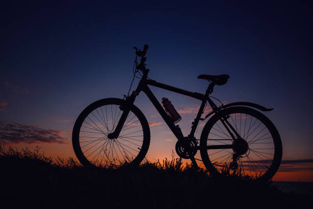 istock silhouette of a bicycle on the sunset sky 1253265644
