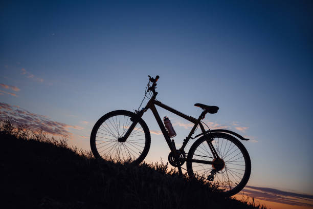 istock silhouette of a bicycle on the sunset sky 1253265992