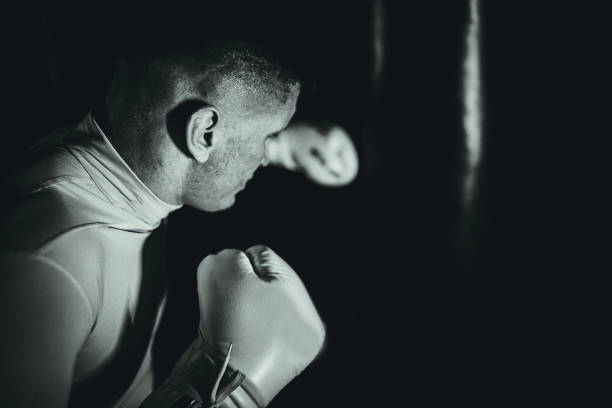 istock One young sportsman punching a bag on a kick box training 1253266011