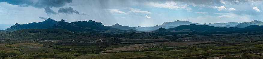 Incredibly beautiful landscape view from the mountain of Klimentyev, Crimea, to the valley before a thunderstorm in spring.