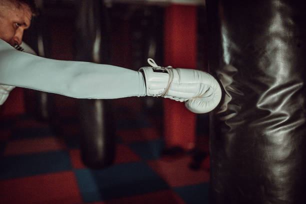 istock Man punching a bag on a kick box training 1253269551