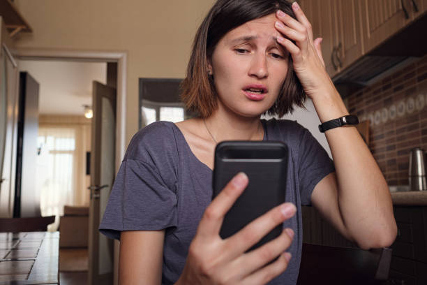 istock Woman text messaging on mobile phone at home 1253271300