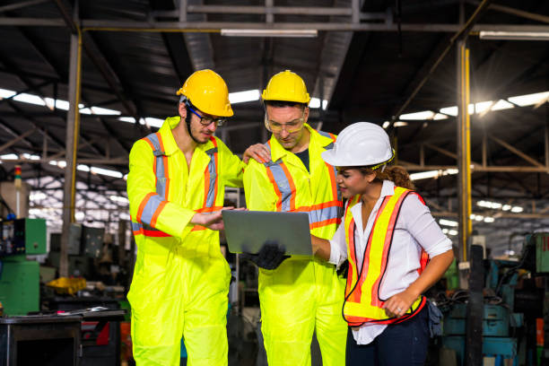 istock Engineers and skilled technicians are holding laptops and working in industrial plants. 1253272596
