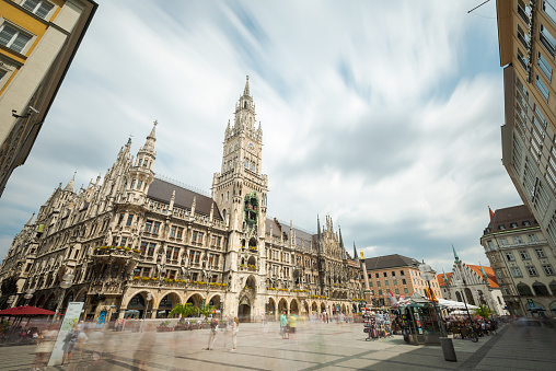 The New Town Hall on Marienplatz in Munich during the day with blurred, blurred people in motion, long exposure