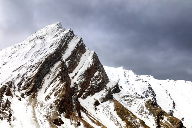 istock Snow covered mountain and stormy sky in Svalbard 1253273213