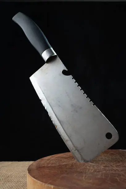 Old cleaver on wooden cutting board