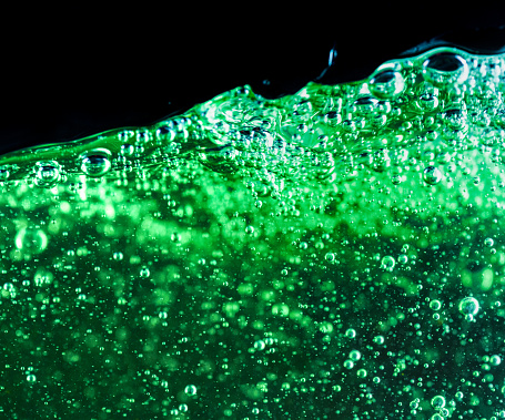 A close-up showing hundreds of microscopic air bubbles in water.