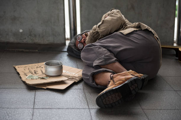 istock Homeless old beggar sleep on walkway 1253274472