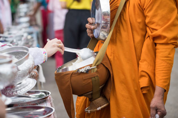 Mon people offer rice to Buddhist monk alms-bowl at morning in village, Sangkhla Buri, Kanchanaburi, Thailand. village religion lifestyle in early morning. Mon people offer rice to Buddhist monk alms-bowl at morning in village, Sangkhla Buri, Kanchanaburi, Thailand. village religion lifestyle in early morning. sangkhla stock pictures, royalty-free photos & images