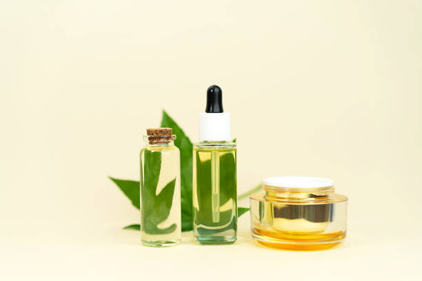 istock Various glass bottles with herbal CBD oil, THC tincture and hemp leaf on pastel beige background. 1253274556