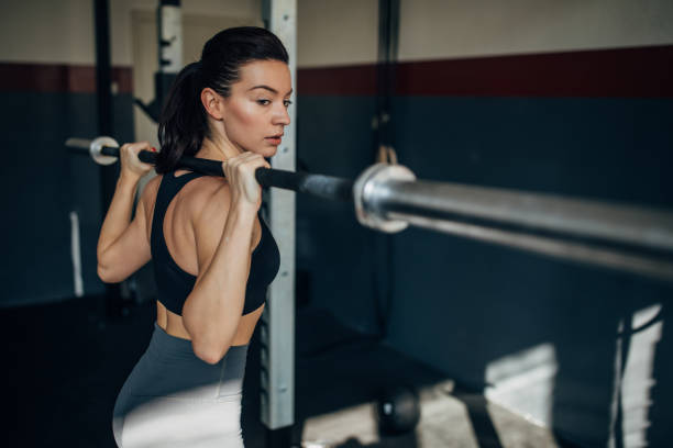 istock Young fit woman training in the gym 1253275947