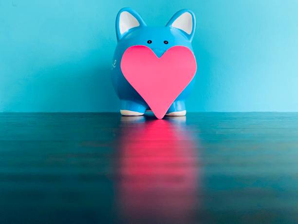istock Blue piggy bank and red heart shape 1253276005