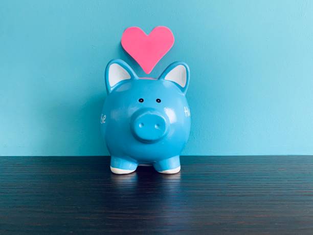 Blue piggy bank and red heart shape