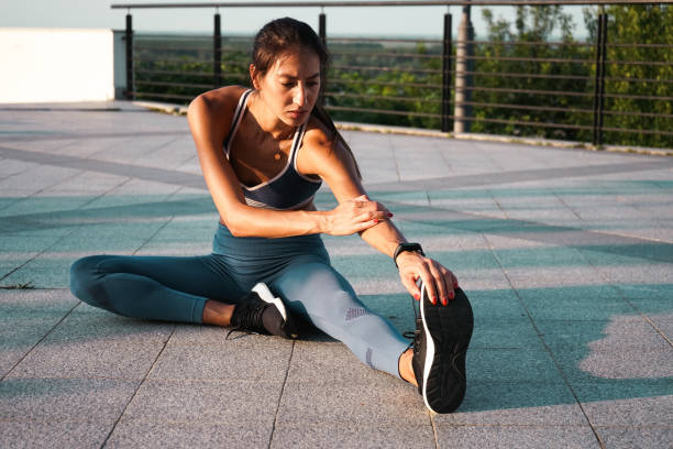 istock Young woman doing a stretching exercise 1253278205