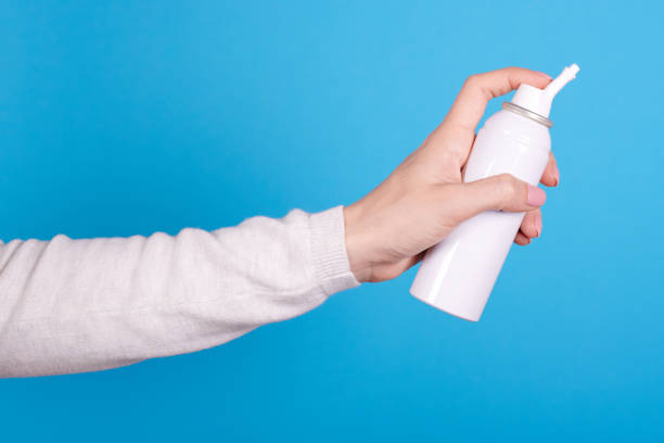 istock White spray bottle with sea water in hand. 1253279455