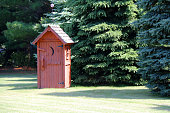 rural red outhouse privy toilet building forest glade