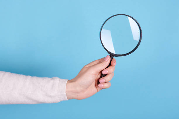 istock Magnifying glass in hand. 1253279850