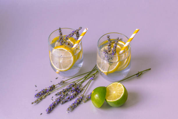 istock Glasses with lavender lemonade on light lilac table 1253282485