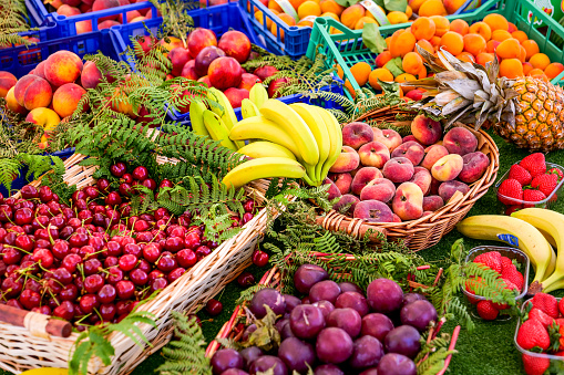 Rome, Italy -- A view of summer fruit with peaches, apricots, bananas and cherries. The traditional Italian cuisine is based on the Mediterranean diet, considered the most balanced and sustainable in the world, composed of natural and fresh and healthy products, including fruit, vegetables and cereals. Image in HD format