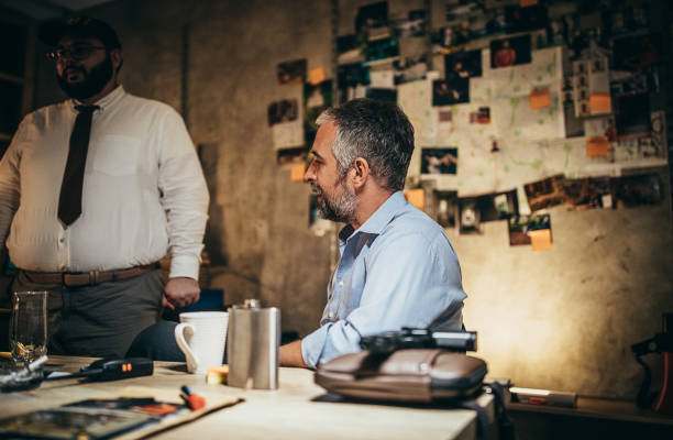 istock Two detectives working together on a case in the office 1253284110