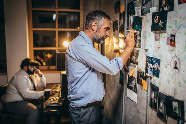 istock Two detectives working on a murder case in the office 1253284160