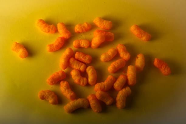 istock Snacks, crochets or cheese puff pastry on white background.Different kinds of popcorn in bowl 1253286202