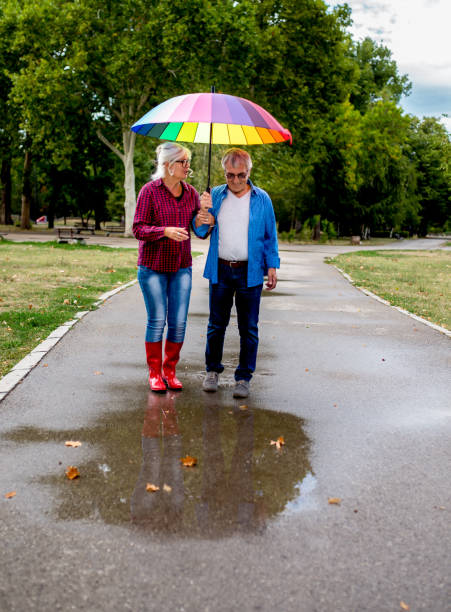 istock Couple walking in wet day 1253287272