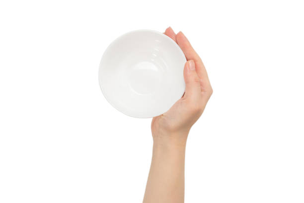 istock White bowl in woman hand isolated on white. 1253287364