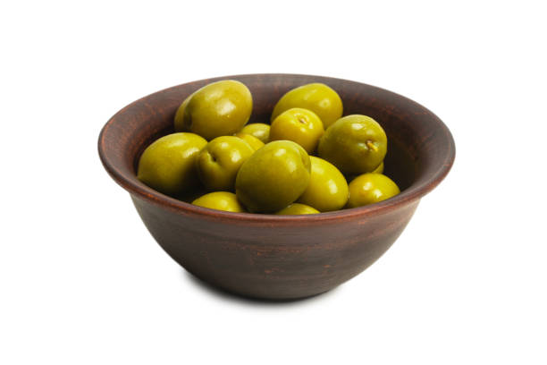 istock Olives in ceramic brown bowl isolated on white 1253287396