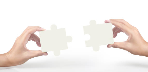 istock Hand of connecting jigsaw puzzle 1253287992