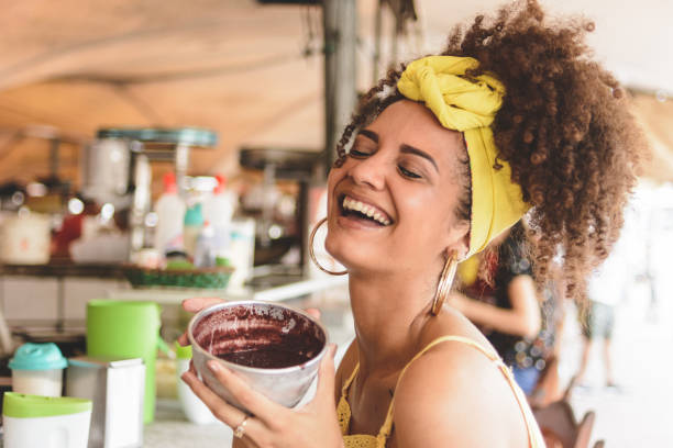 Woman holding a bowl with acai at Ver o Peso market, in Belem do Para Woman holding a bowl with acai at Ver o Peso market, in Belem do Para belém brazil stock pictures, royalty-free photos & images