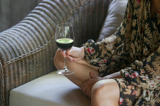 Woman holding a glass of red wine, close up