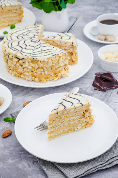 istock Traditional Hungarian Esterhazy cake on a white plate on a stone background with a cup of coffee, mint and almonds. 1253289504