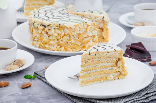 istock Traditional Hungarian Esterhazy cake on a white plate on a stone background with a cup of coffee, mint and almonds. 1253289518