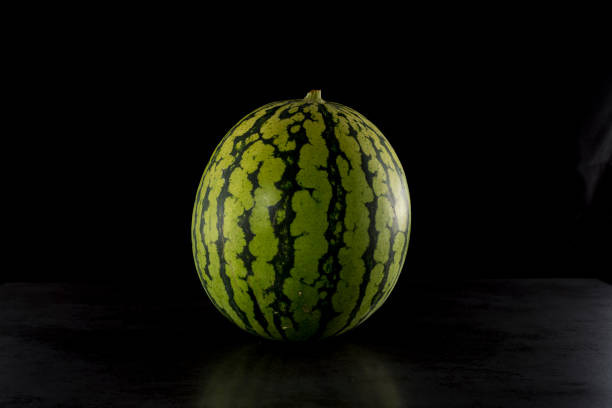 Pieces of watermelon in a black tray on a black background