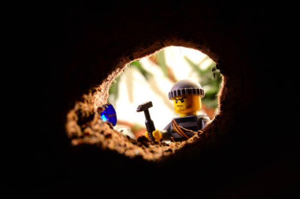Toy Mini-Figure Blue Jewel Excavation Realistic Diorama of a tiny plastic Toy Minifigure Explorer / Adventurer / Miner / Archaeologist / Thief / Villain discovering blue jewel excavating in dirt hole in the ground. In the background, a jungle setting. action figure stock pictures, royalty-free photos & images