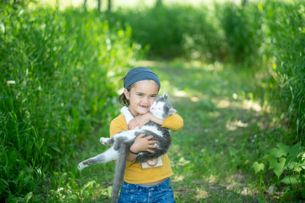 istock Cute little girl and her cat 1253291782