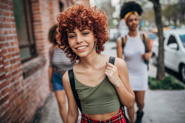 istock Happy women walking down the street 1253291942