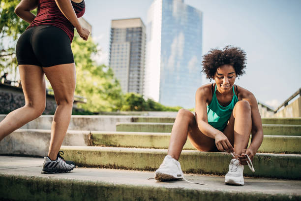 istock Beautiful black woman tying shoelace 1253292247