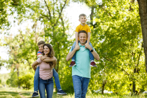 istock Parents piggybacking their sons in the park 1253292917