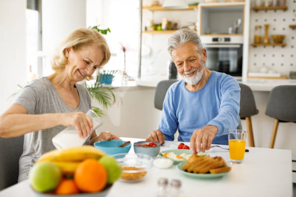 istock Senior couple having a breakfast together at home 1253293374