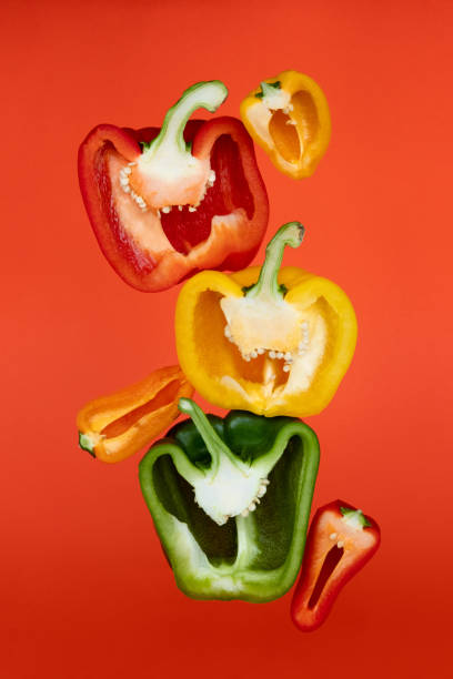 istock Sliced paprika on orange background. Cooking concept. 1253294784