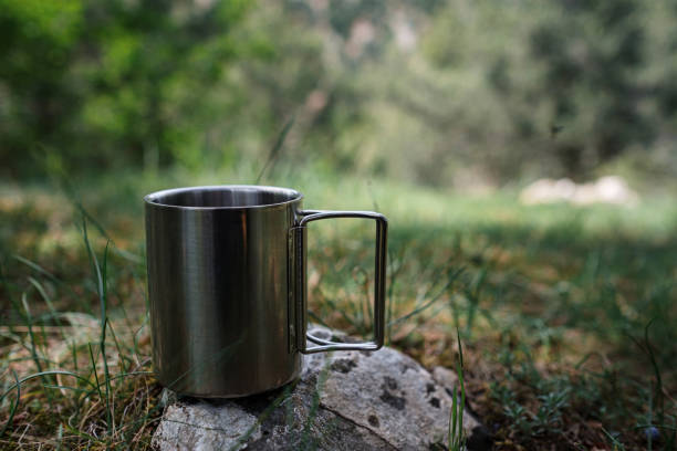 istock A mug with a hot drink stands on a stone in nature. 1253297862