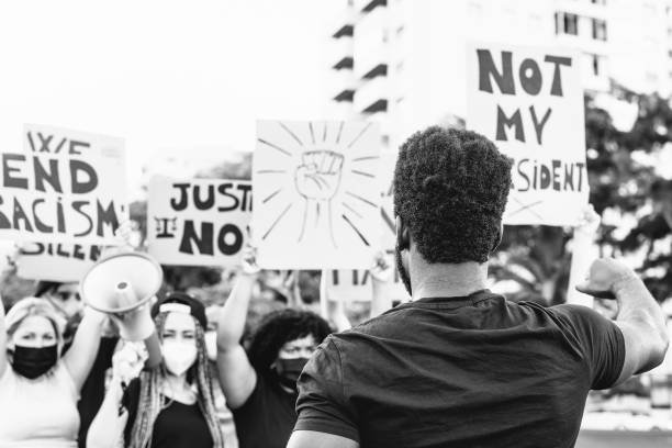 istock protest activist movement protesting against racism and fighting for equality - Demonstrators from different cultures and race protest on street for justice and equal rights 1253299117