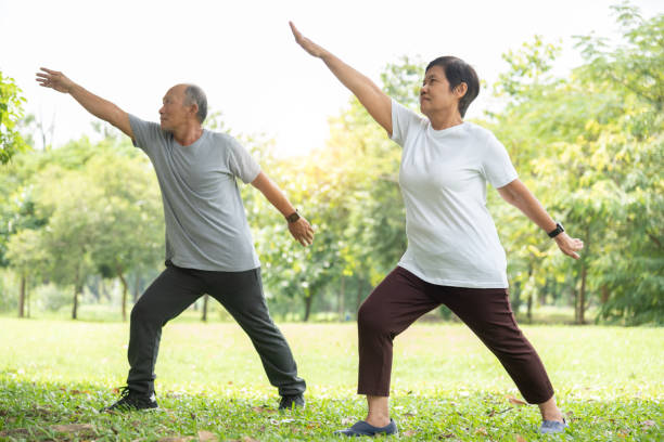 istock Senior couple doing stretching exercise at park. 1253300322
