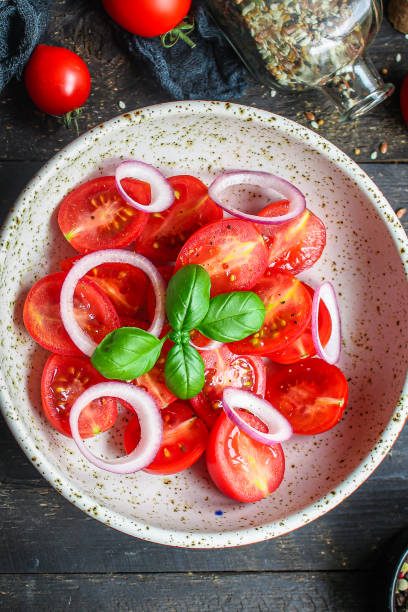 istock salad red tomato vegetables Menu concept serving size. food background top view copy space for text keto or paleo diet 1253303385