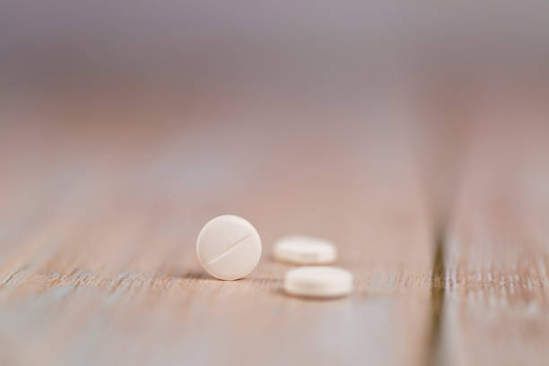 istock Home therapy. Close-up round white pills. Macro 1253304585