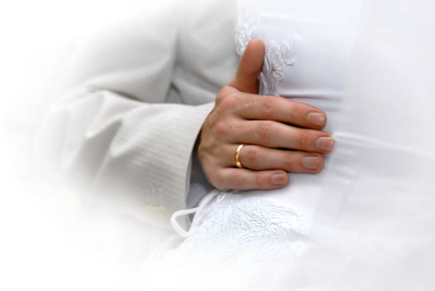 istock Just Married. Grooms hand with gold ring 1253304710